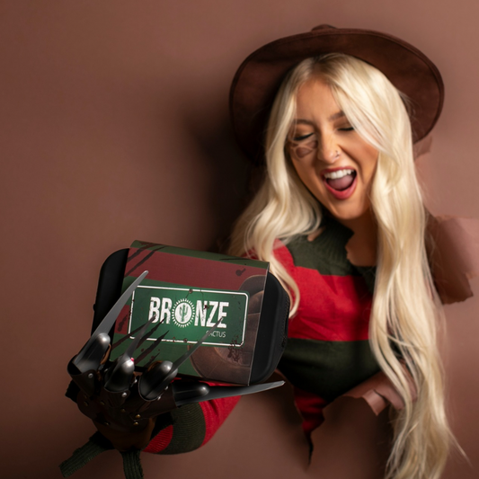 Woman holding a product with 'Bronze' branding against a brown background